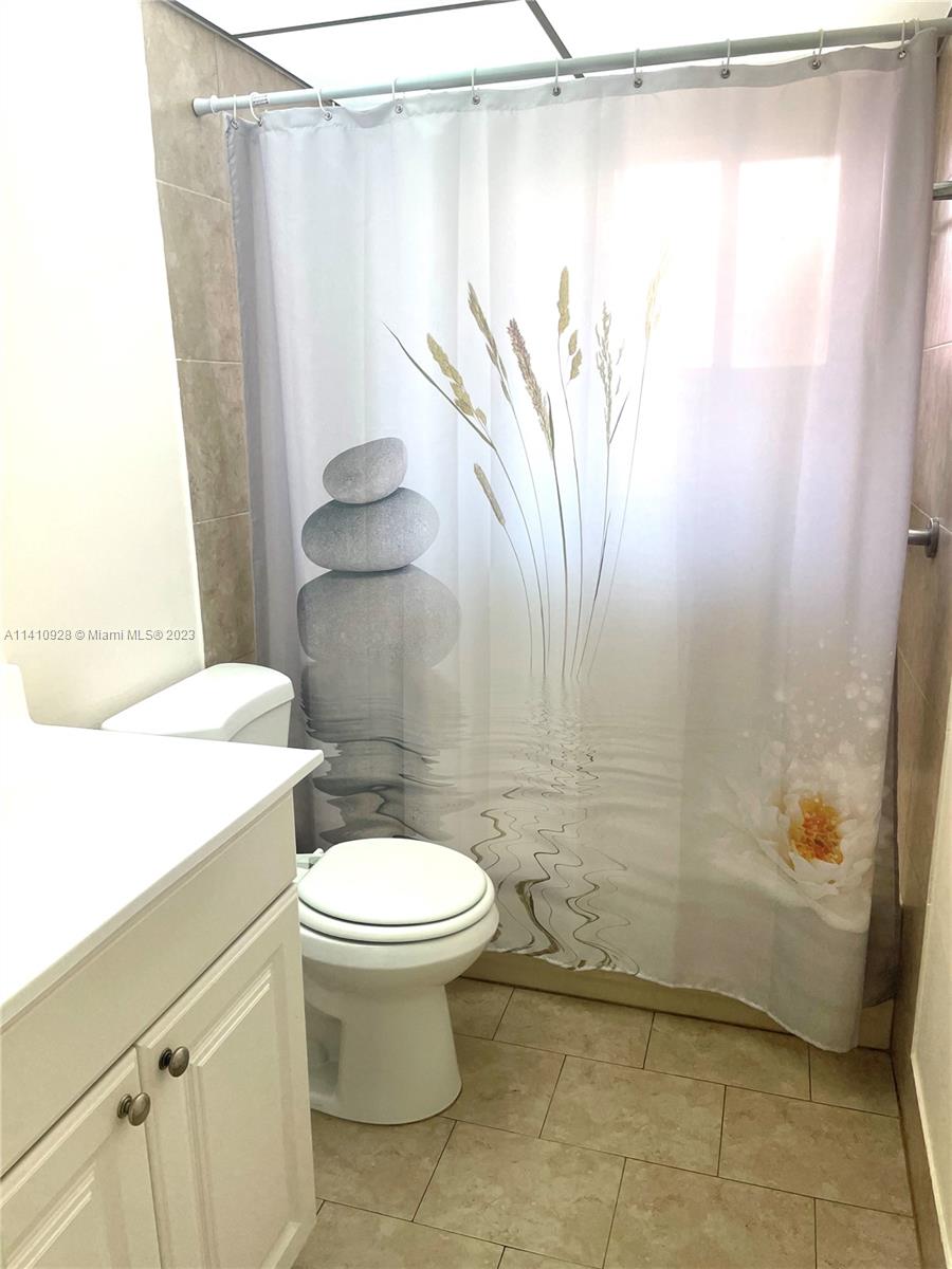 8600 Southwest 133rd Avenue Road, Unit 416 Miami, FL 33183 - Photo 10 of 23 a bathroom with a sink a toilet and shower