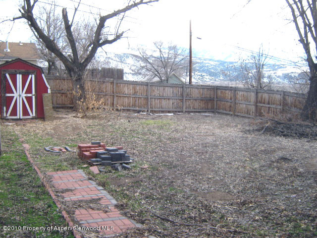 323 East 2nd Street Rifle, CO 81650 - Photo 2 of 5 a backyard of a house with lots of green space