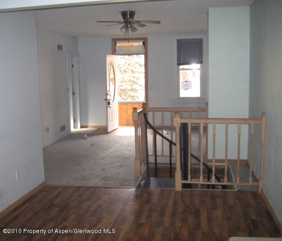 323 East 2nd Street Rifle, CO 81650 - Photo 5 of 5 a view of a livingroom with wooden floor and a window
