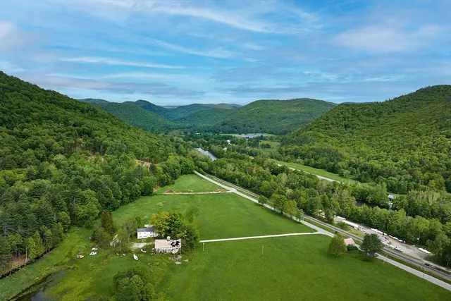a view of a green field with an ocean view