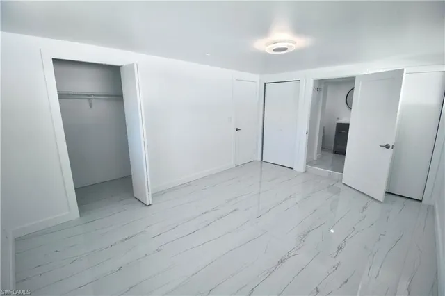 an empty room with wooden floor and closet