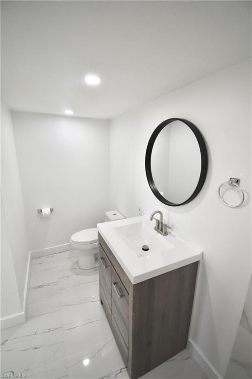 2116 Pineview Road Fort Myers, FL 33901 - Photo 18 of 25 a bathroom with a sink mirror and a toilet