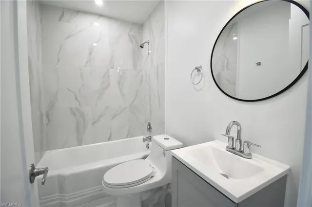 a bathroom with a sink toilet and a mirror