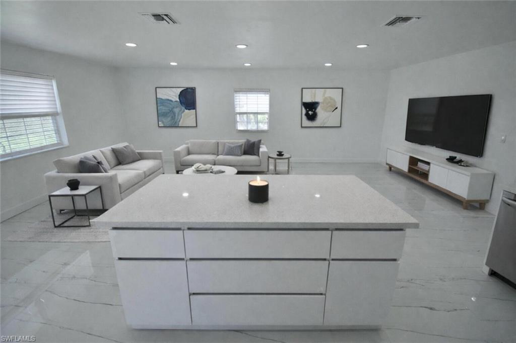 2116 Pineview Road Fort Myers, FL 33901 - Photo 2 of 25 a living room with furniture a flat screen tv and a window