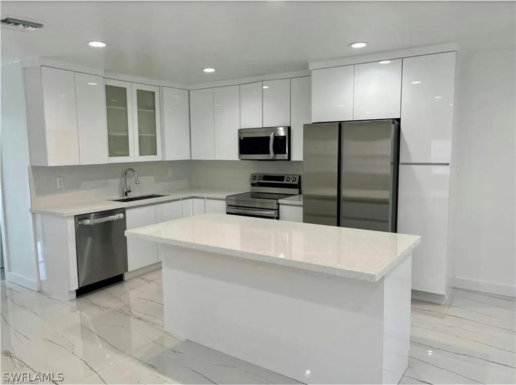 2116 Pineview Road Fort Myers, FL 33901 - Photo 4 of 25 a kitchen with granite countertop a refrigerator and a stove top oven