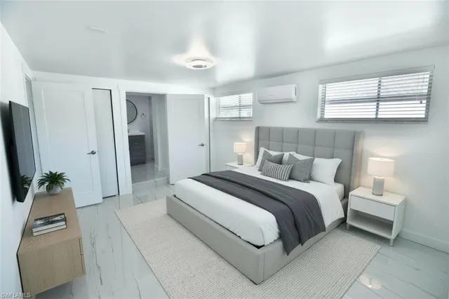 a bedroom with a bed and a flat screen tv