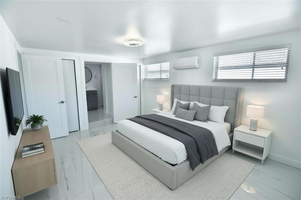 2116 Pineview Road Fort Myers, FL 33901 - Photo 10 of 25 a bedroom with a bed and a flat screen tv