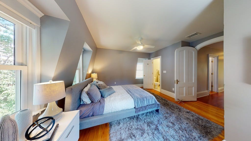 27 Inman Street Cambridge, MA 02139 - Photo 15 of 32 a spacious bedroom with a bed and a window