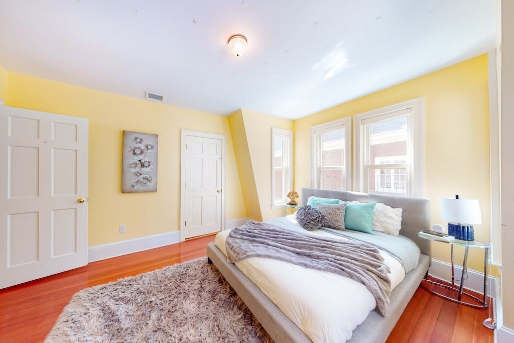 27 Inman Street Cambridge, MA 02139 - Photo 17 of 32 a bedroom with a bed and wooden floor