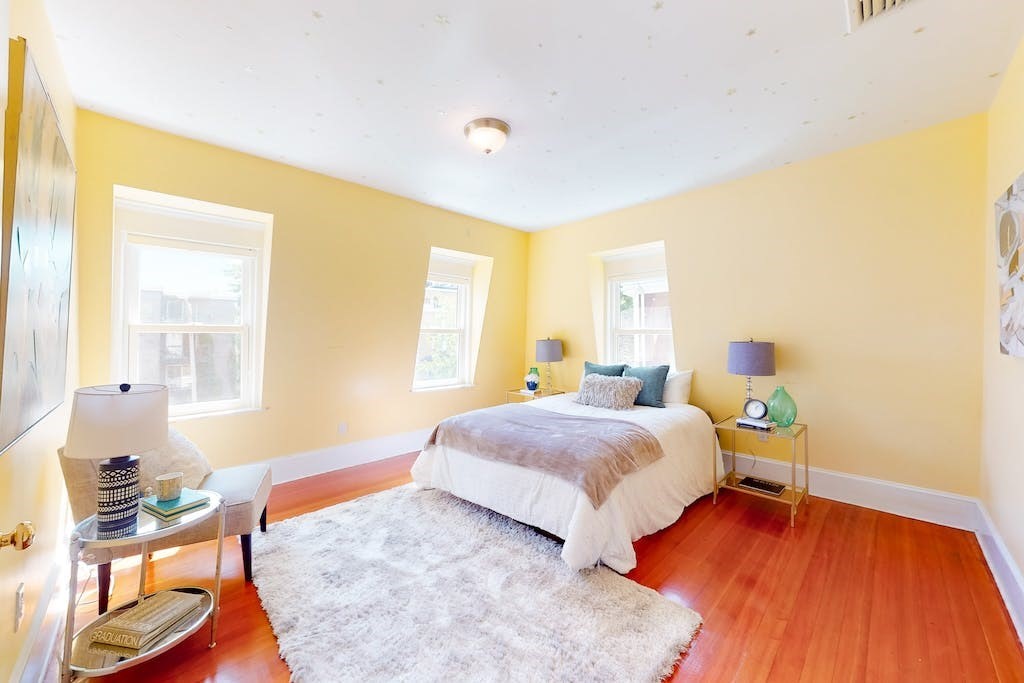 27 Inman Street Cambridge, MA 02139 - Photo 18 of 32 a bedroom with a bed and wooden floor