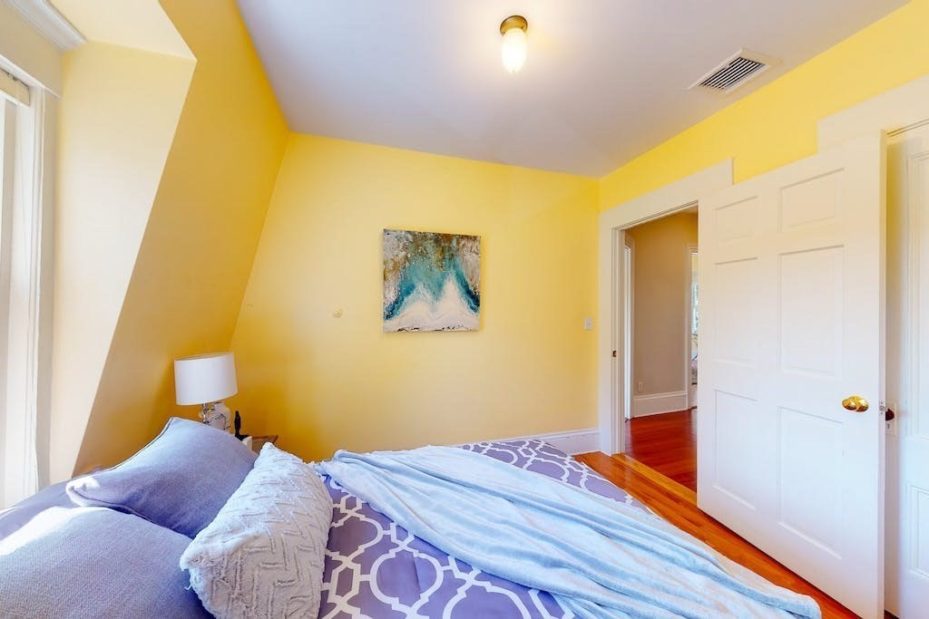 27 Inman Street Cambridge, MA 02139 - Photo 19 of 32 a bedroom with a bed and wooden floor