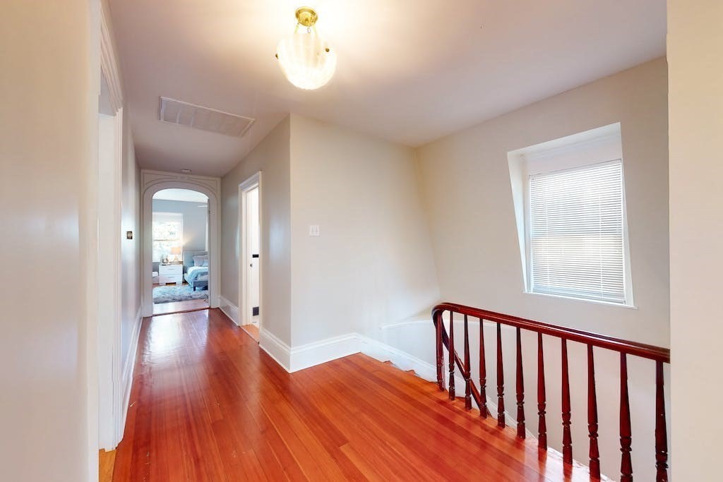 27 Inman Street Cambridge, MA 02139 - Photo 21 of 32 a view of a hallway view with wooden floor and staircase