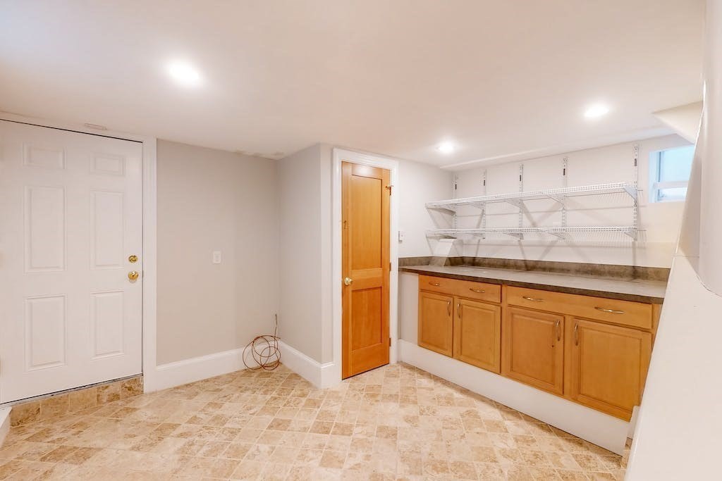27 Inman Street Cambridge, MA 02139 - Photo 25 of 32 a kitchen with granite countertop cabinets and refrigerator