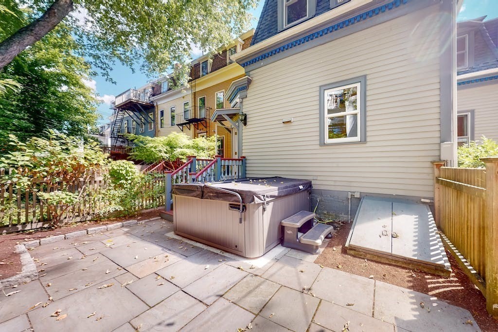 27 Inman Street Cambridge, MA 02139 - Photo 28 of 32 a view of a patio with chair and tables back yard of the house