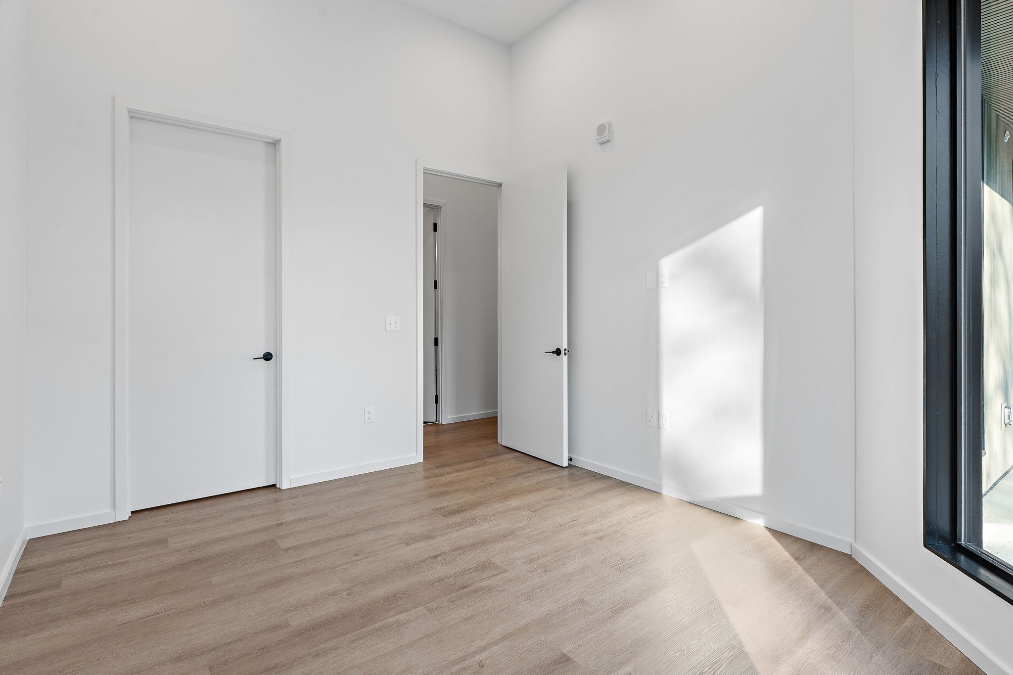 504 Merritt Avenue Nashville, TN 37203 - Photo 15 of 23 a view of an empty room with wooden floor and a window