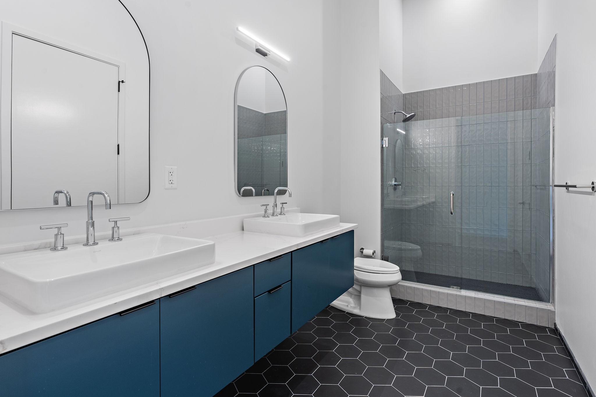 504 Merritt Avenue Nashville, TN 37203 - Photo 16 of 23 a bathroom with a double vanity sink toilet and shower