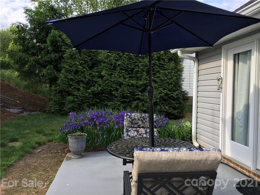 44 Cottage Ridge Road Fletcher, NC 28732 - Photo 22 of 24 a view of a chair and table under an umbrella