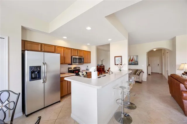 a kitchen with refrigerator a sink and cabinets