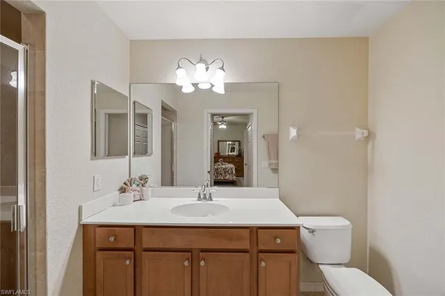 a bathroom with a sink a toilet and a mirror