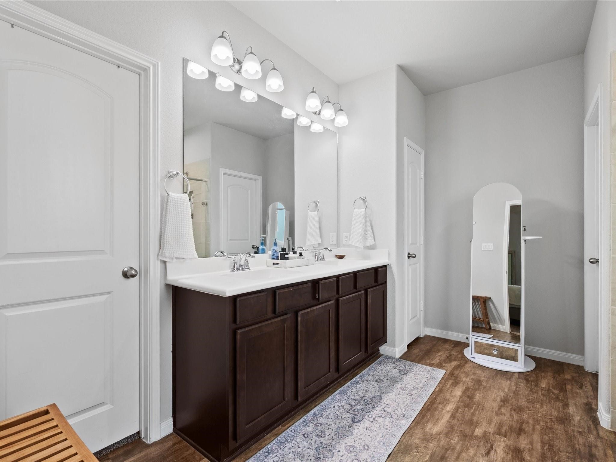 14381 Whitetop Peak Court Conroe, TX 77384 - Photo 13 of 39 a bathroom with a sink vanity and a mirror