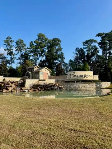 a view of swimming pool with a yard and large trees