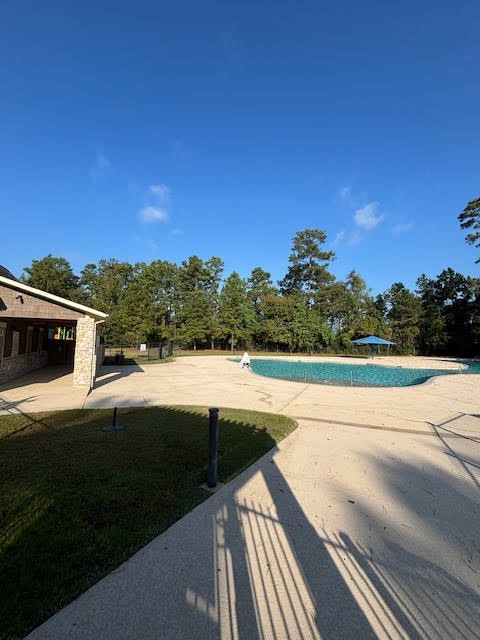 14381 Whitetop Peak Court Conroe, TX 77384 - Photo 29 of 39 a view of a terrace with yard