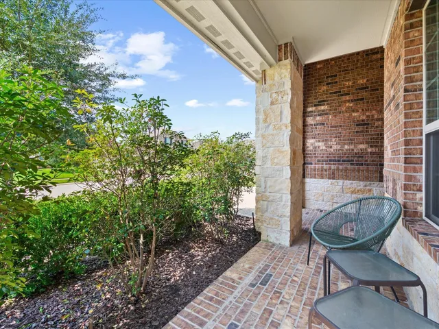a view of a chair and table in the patio