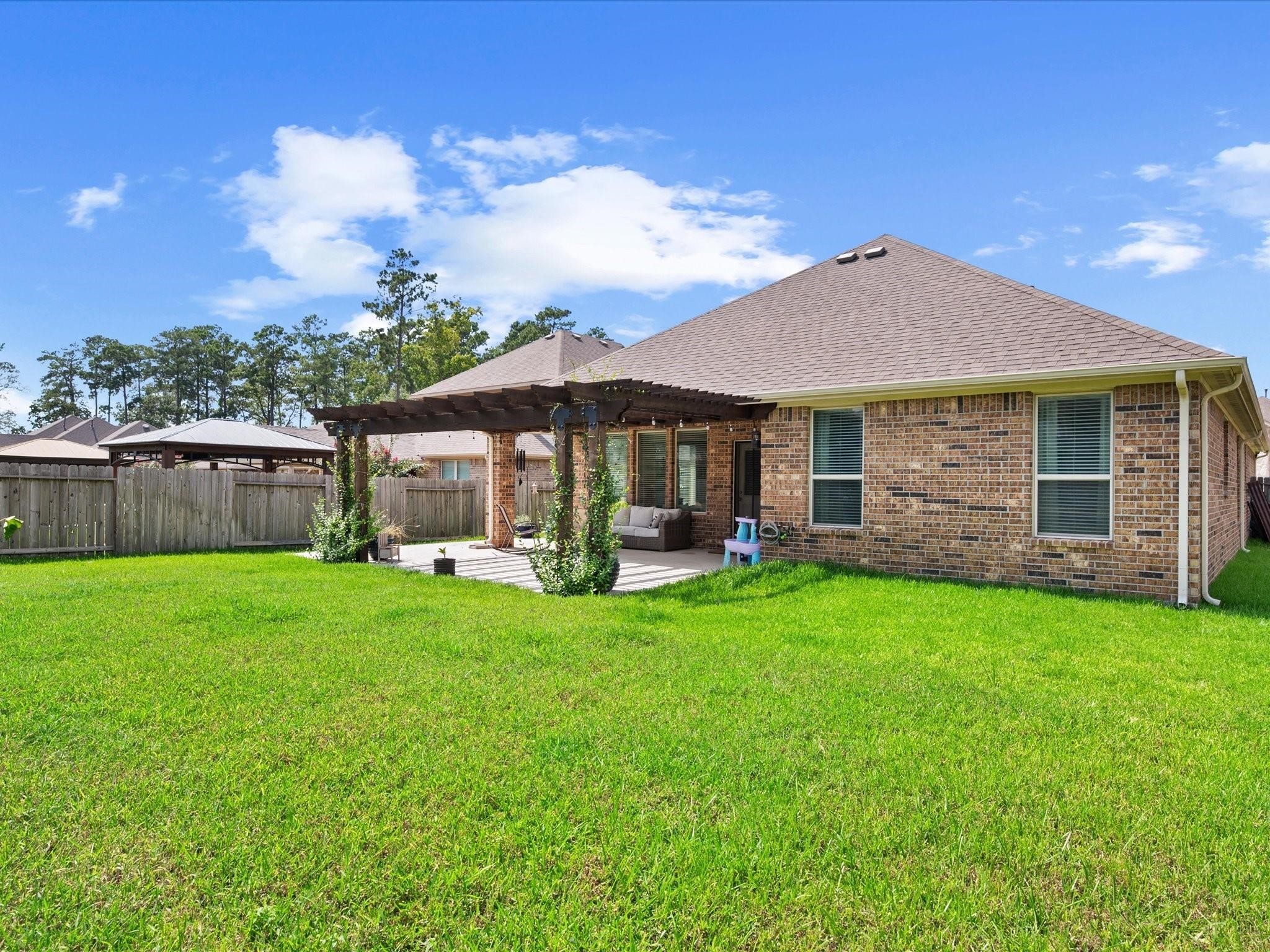14381 Whitetop Peak Court Conroe, TX 77384 - Photo 39 of 39 a view of a house with backyard and garden