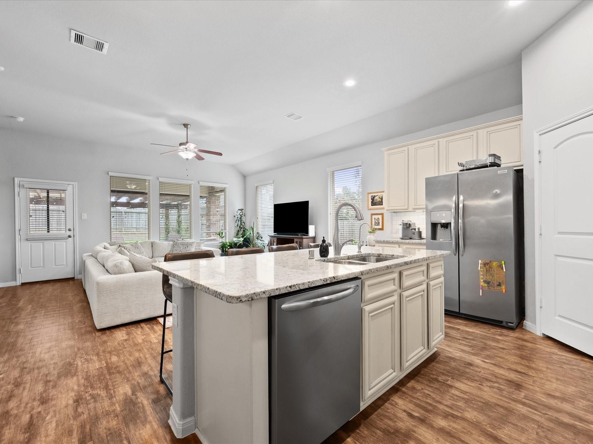 14381 Whitetop Peak Court Conroe, TX 77384 - Photo 8 of 39 a kitchen with stainless steel appliances granite countertop a sink stove and refrigerator