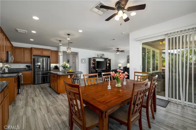 a dining room with furniture window and wooden floor