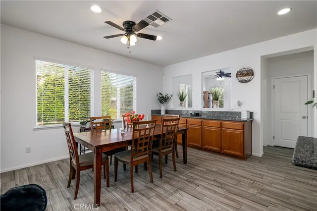 a view of a dining room with furniture window and wooden floor