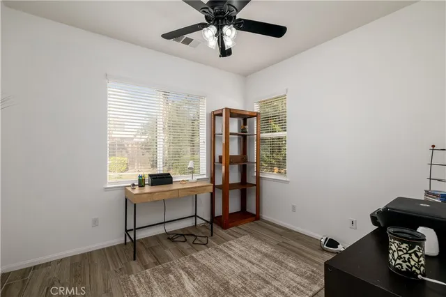 a view of a workspace with furniture and a window