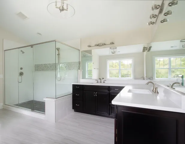 a spacious bathroom with a sink double vanity and a mirror