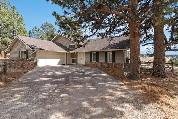 a view of a house with a tree in front