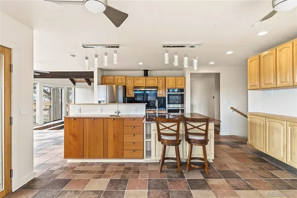 a large kitchen with a table and chairs