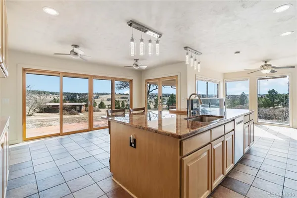 a kitchen with stainless steel appliances granite countertop a sink and cabinets
