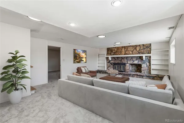 a living room with furniture and a potted plant