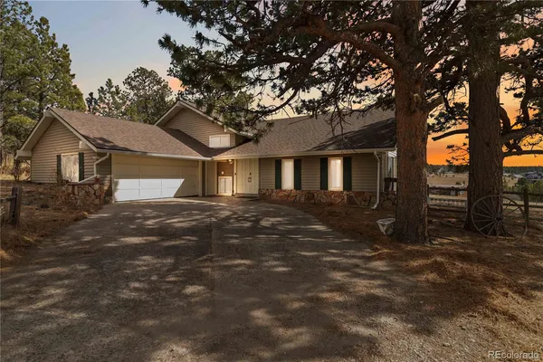 a view of a house with a tree in front of it