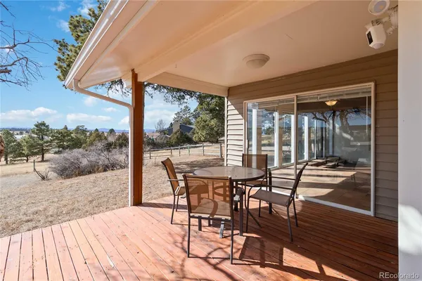 a view of a patio with a table and chairs