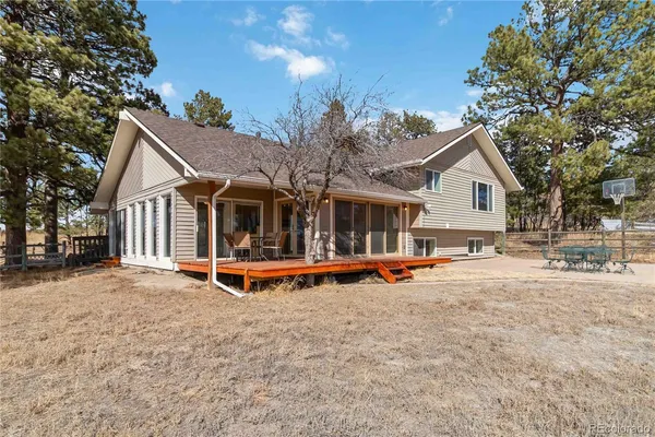 a view of a house with pool and sitting area