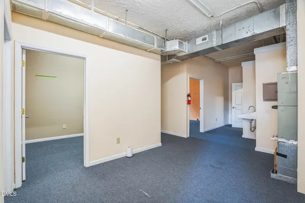a view of a hallway with bathroom and a shower