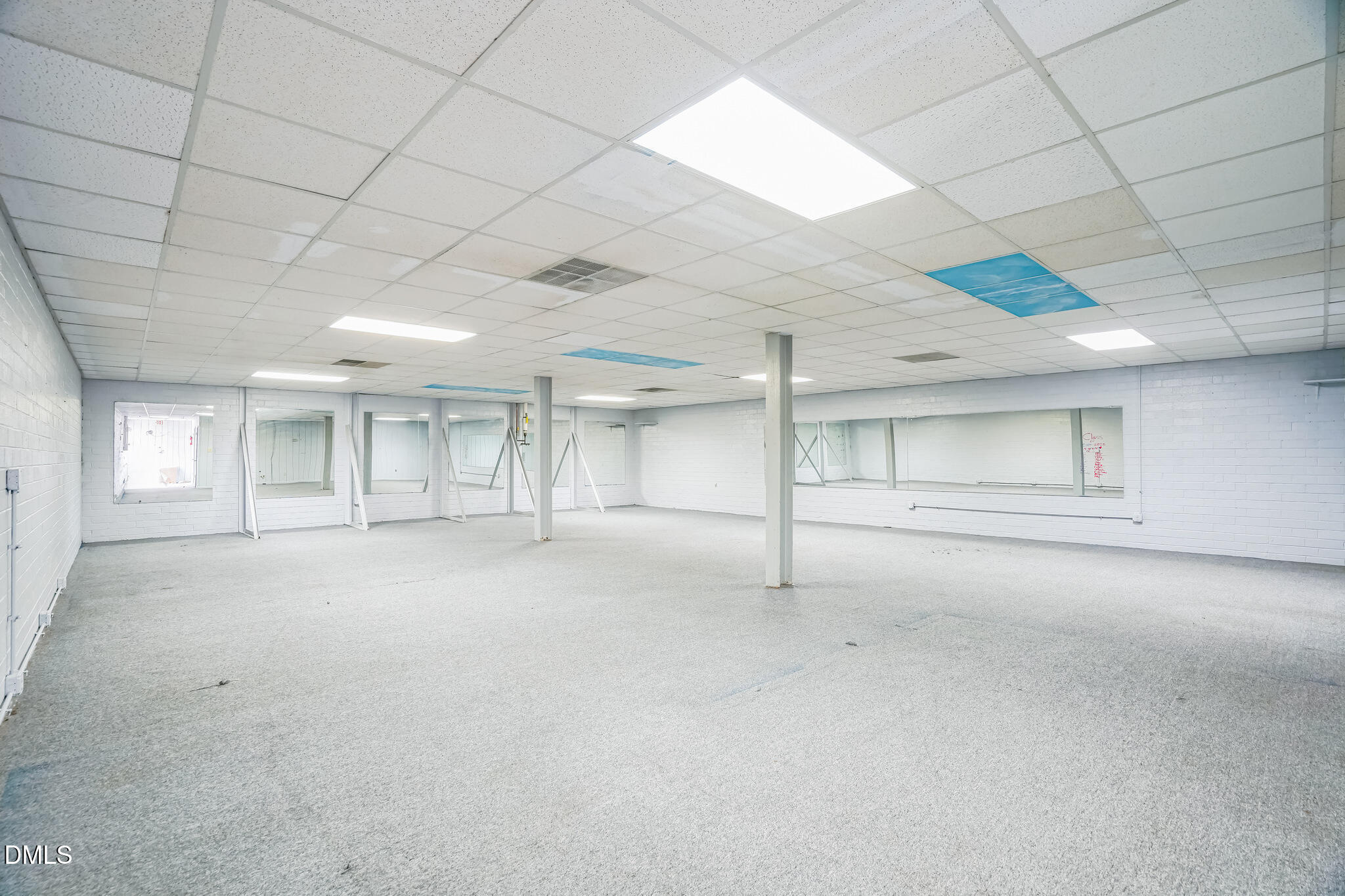 225 South Madison Boulevard Roxboro, NC 27573 - Photo 14 of 19 an empty room with chandelier fan and windows
