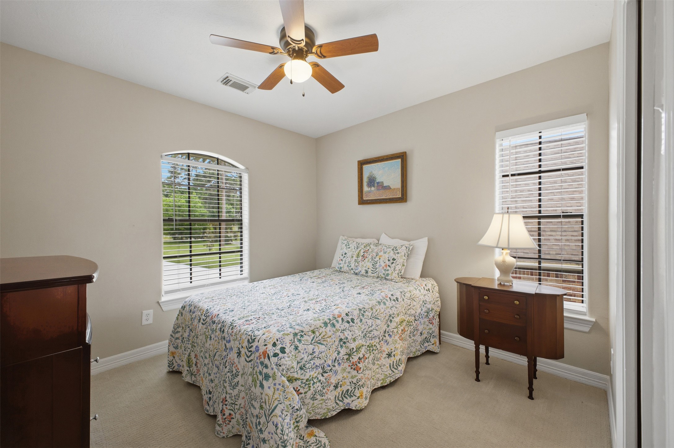 12710 Aries Loop Willis, TX 77318 - Photo 24 of 40 This bright room features a ceiling fan, carpeted flooring, and two windows allowing for natural light