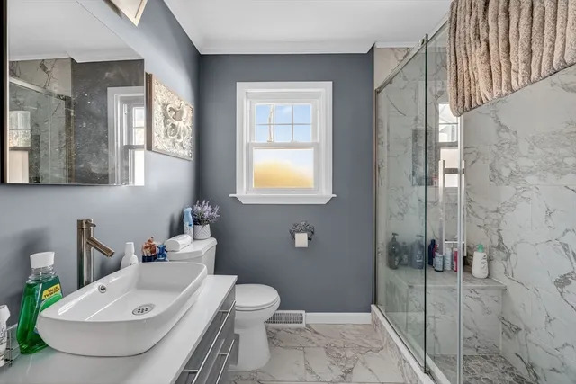 a bathroom with a sink toilet and shower