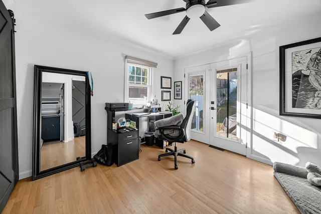 a view of a livingroom with workspace and a window