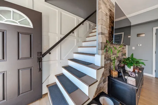 a view of entryway and hall with wooden floor