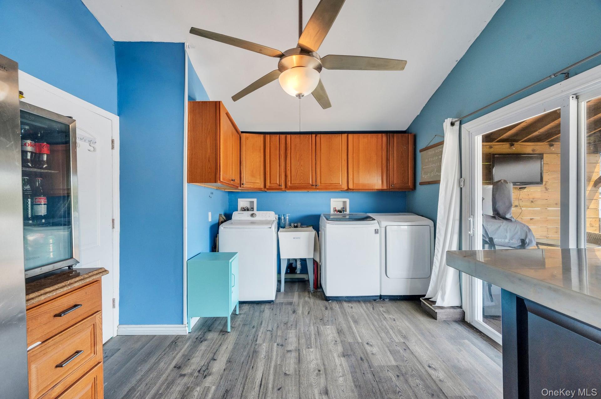 24 Raynor Street West Babylon, NY 11704 - Photo 22 of 45 Washroom with light wood finished floors, washing machine and dryer, and ceiling fan