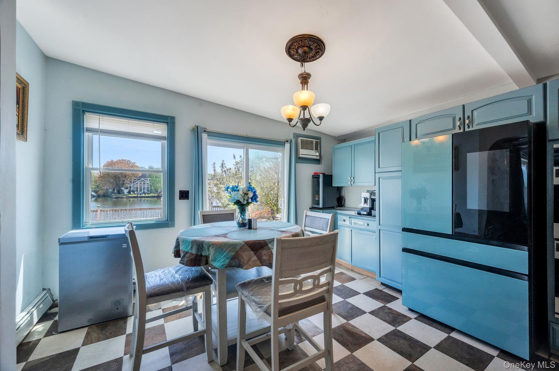 24 Raynor Street West Babylon, NY 11704 - Photo 24 of 45 Dining room featuring light floors and a baseboard heating unit