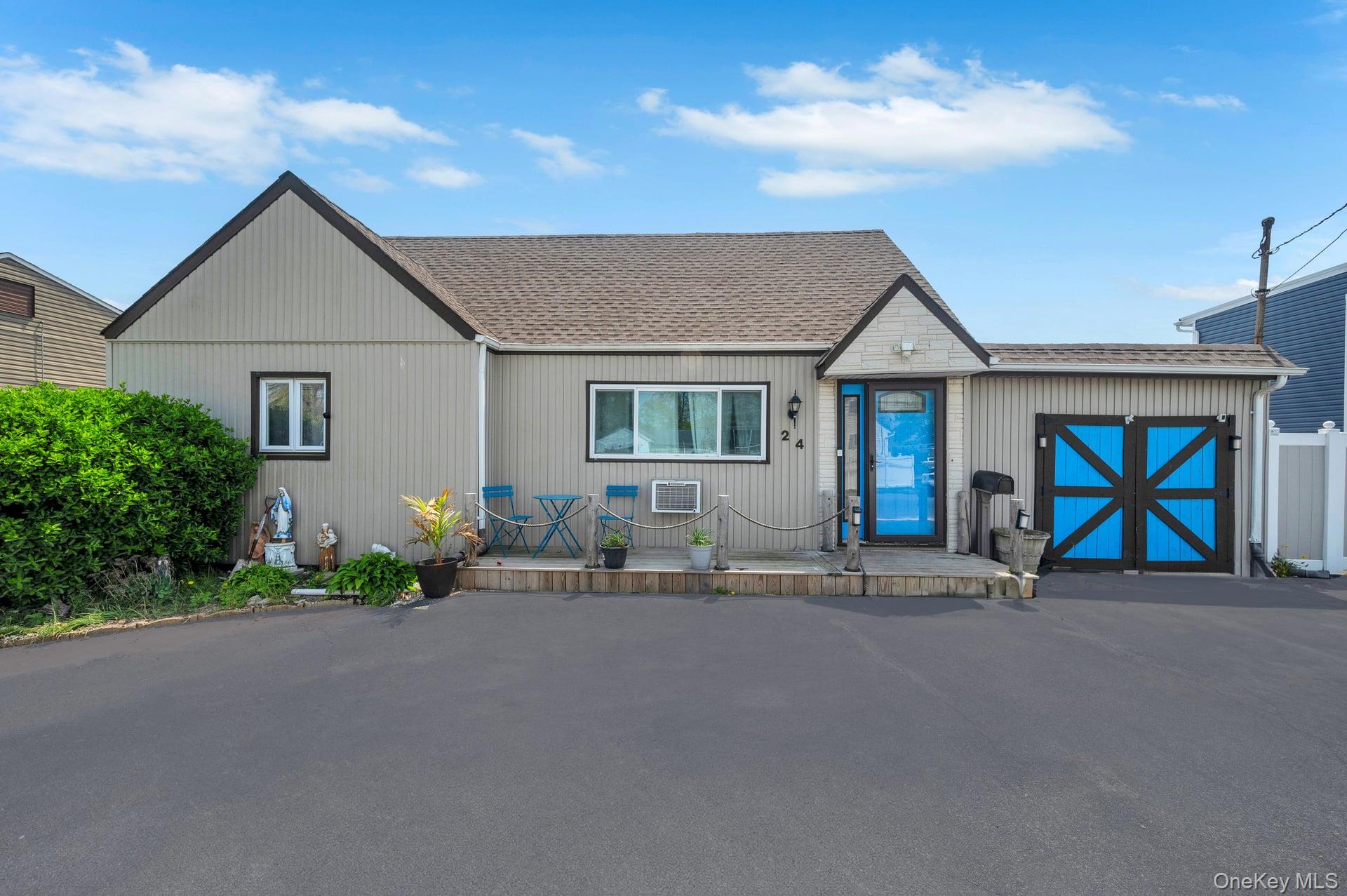 24 Raynor Street West Babylon, NY 11704 - Photo 3 of 45 View of front facade with a shingled roof and a wooden deck