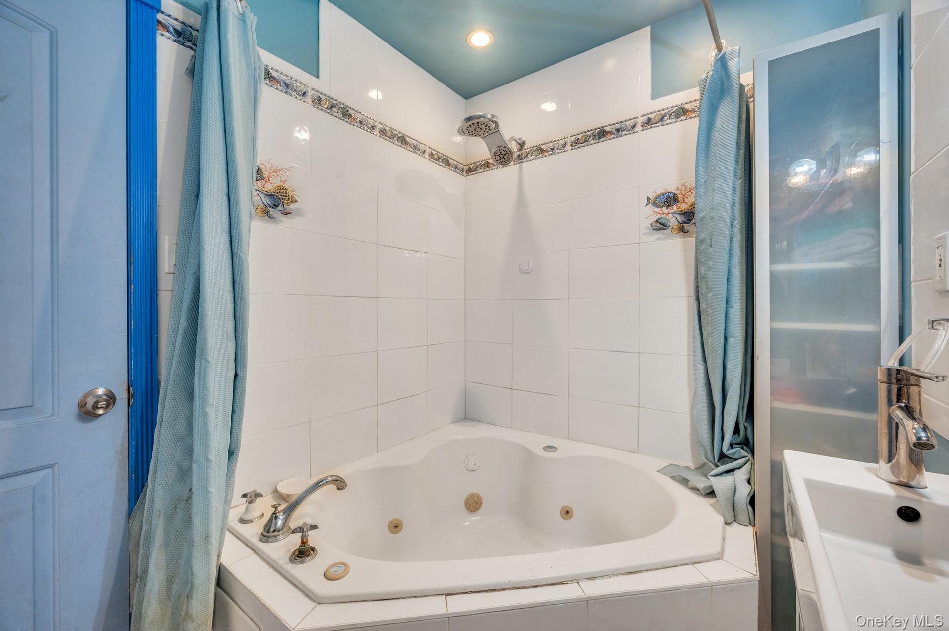 24 Raynor Street West Babylon, NY 11704 - Photo 39 of 45 Bathroom with a sink and a combined bath / shower with jetted tub